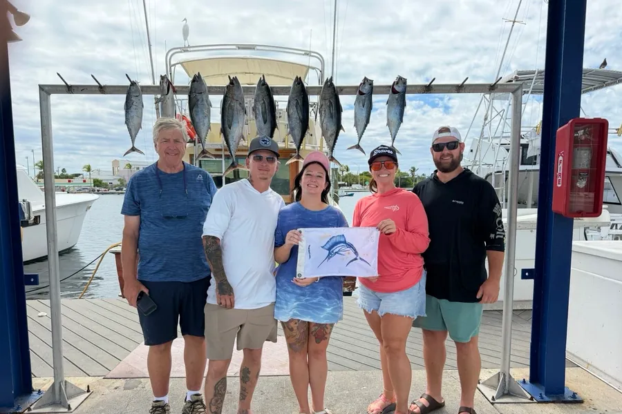 Group at the Key West dock with a rack of blackfin tuna and a sailfish release flag