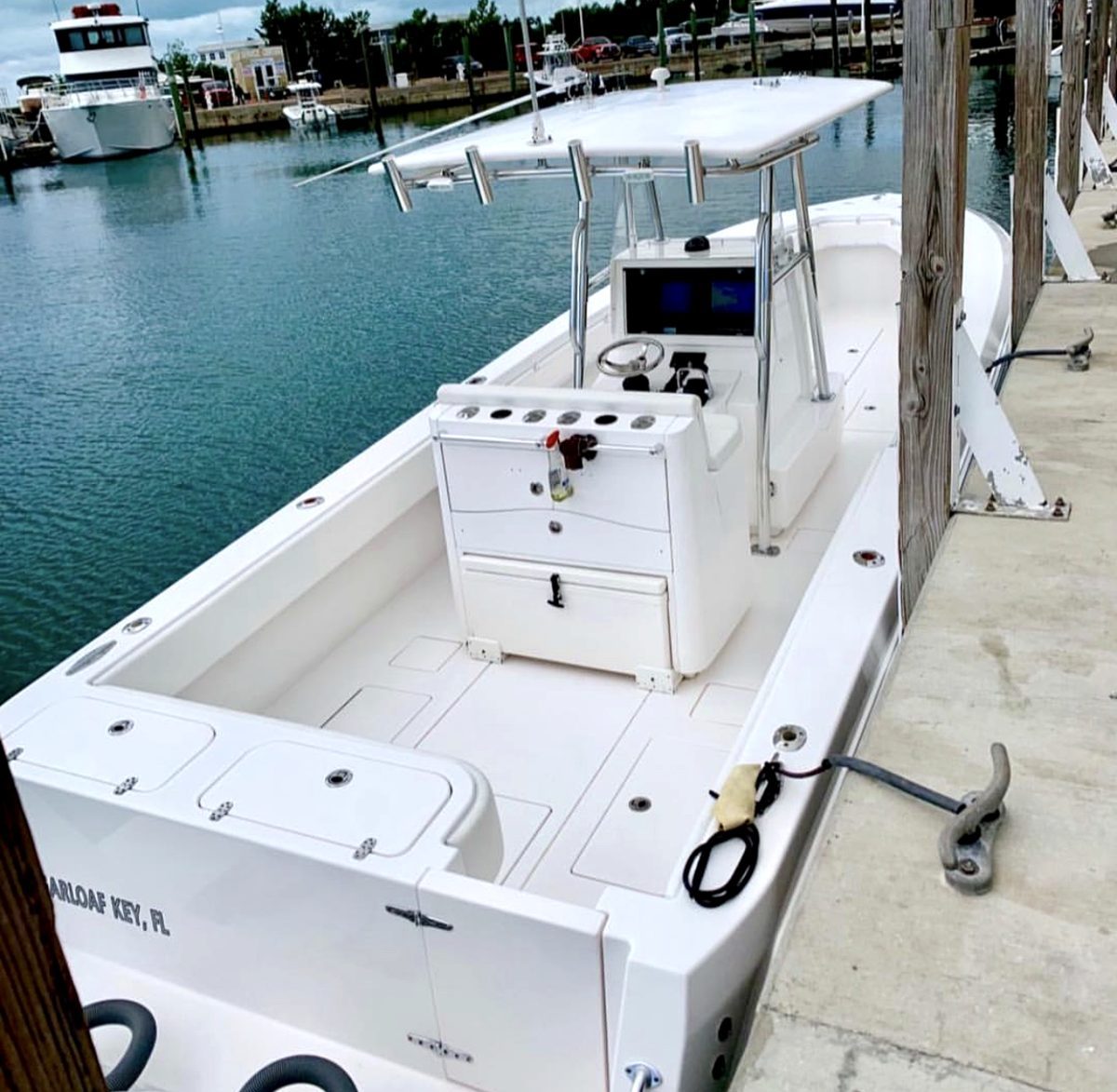 Blue Cowboy – helm and center console setup with electronics and rod holders at the dock, Key West FL
