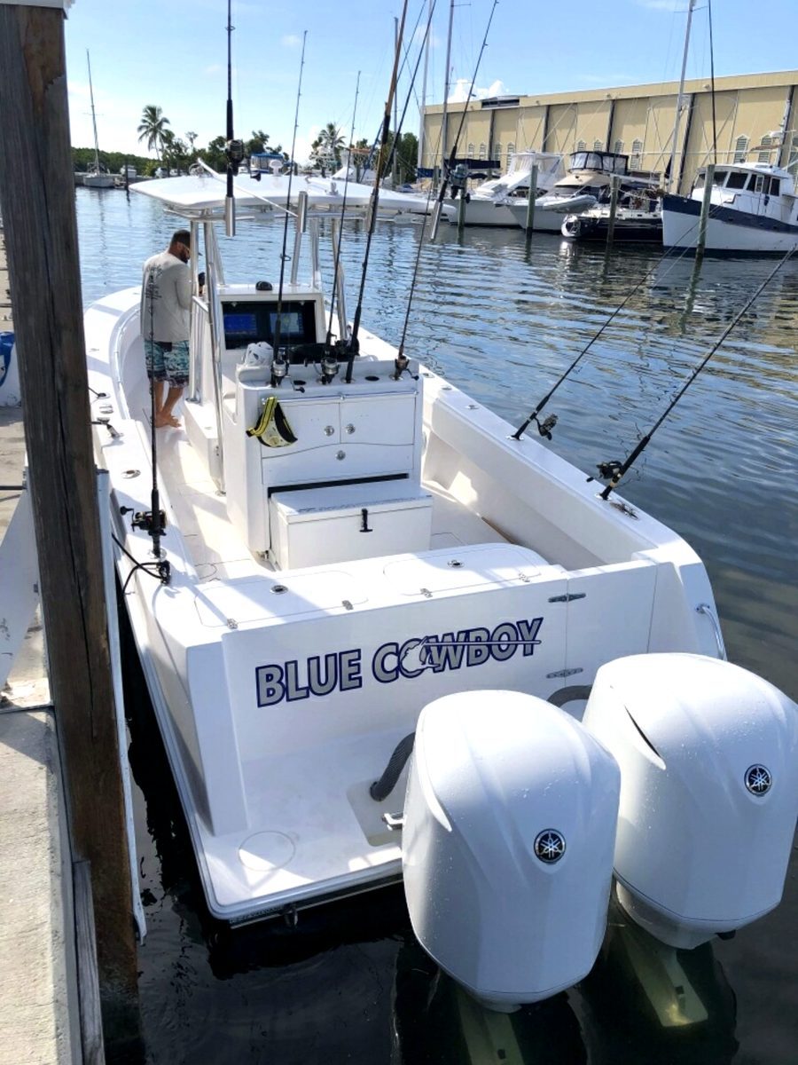 Blue Cowboy – stern with twin Yamaha outboards and the Blue Cowboy hull graphic at the dock, Key West FL