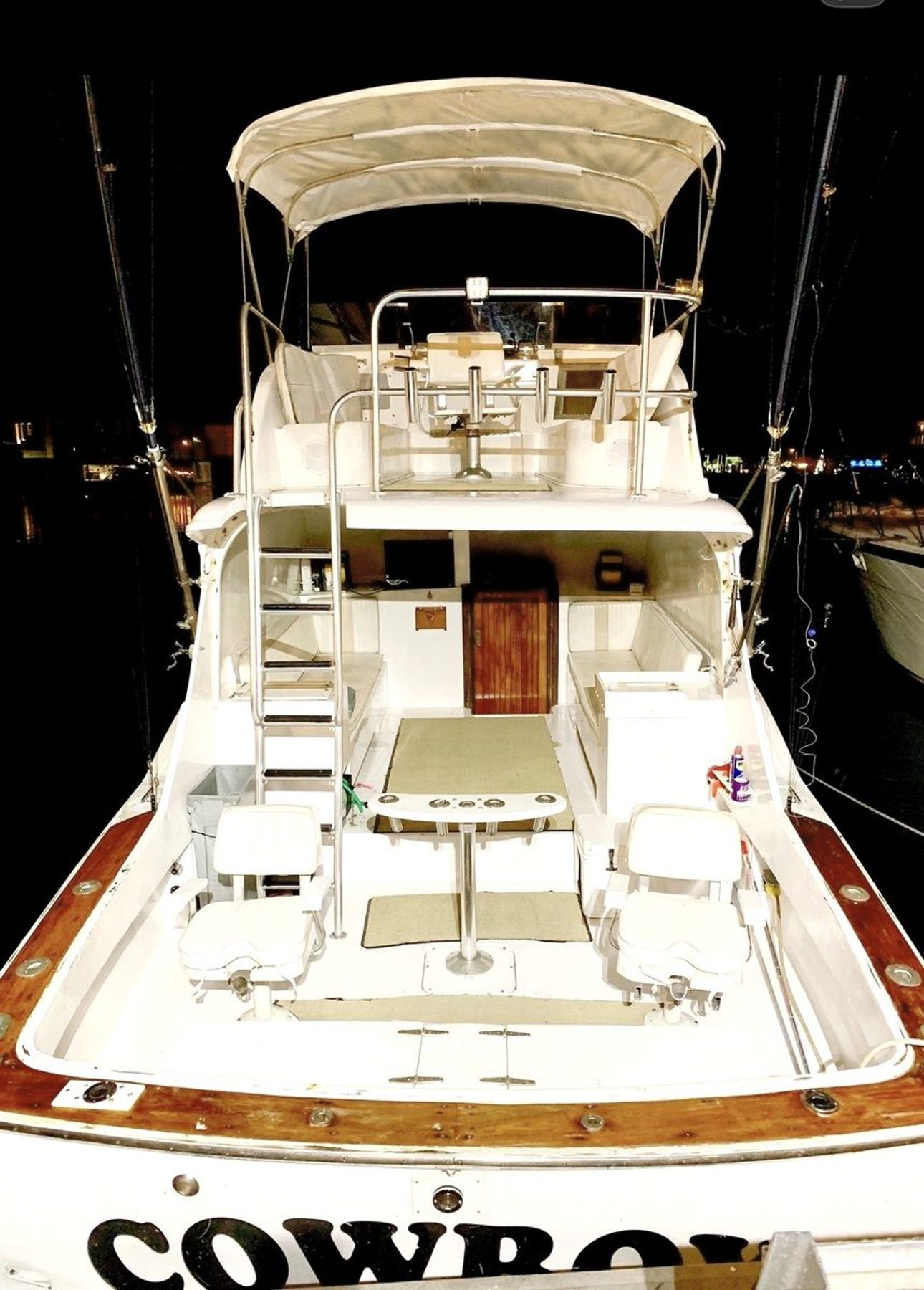 The Cowboy – aft cockpit and fighting deck seen from the flybridge with tower, ladder, mezzanine seating and teak trim, Key West FL