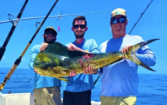 Group with a mahi caught on a private Key West fishing charter