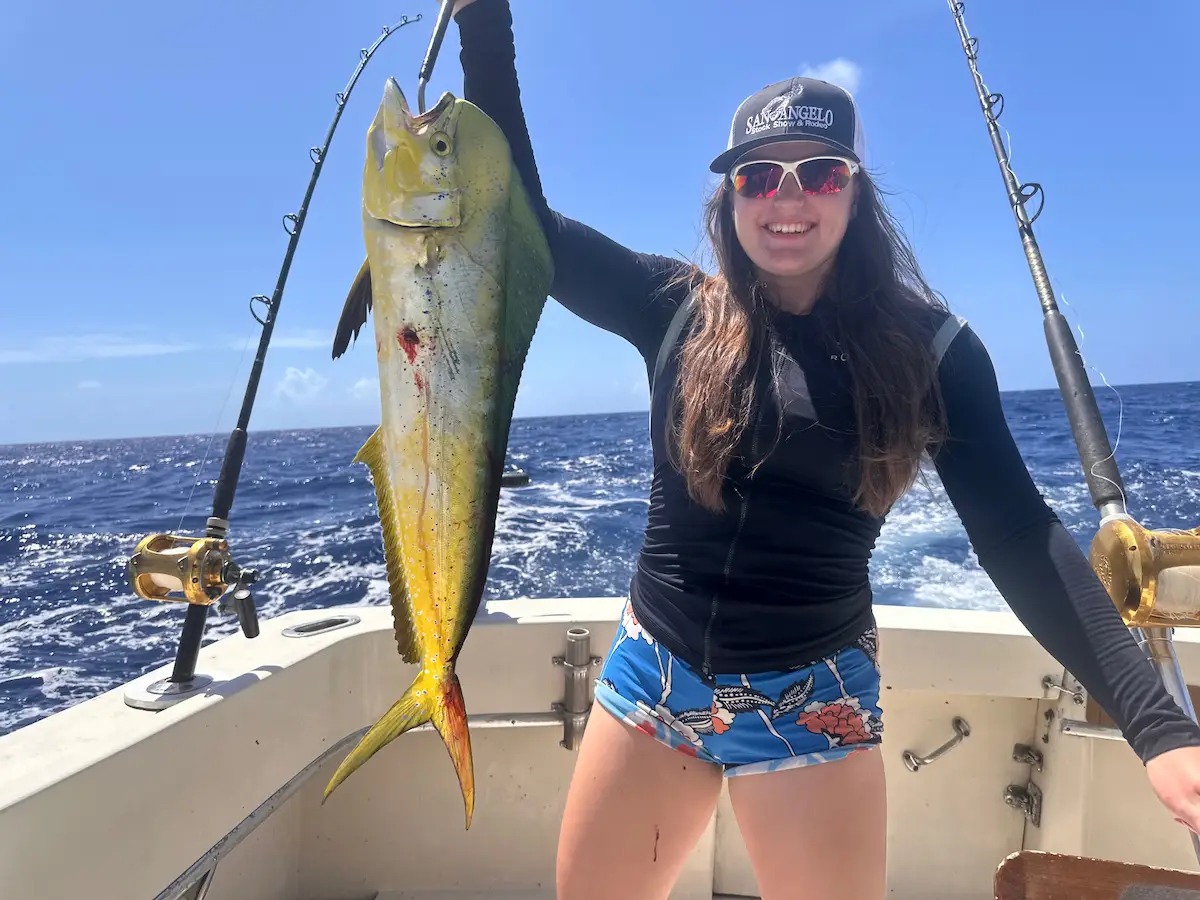 Lady angler proudly displaying her mahi-mahi catch