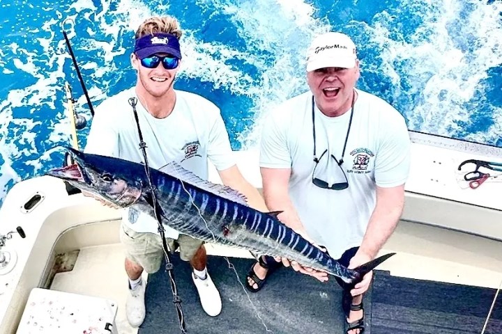 a man standing next to a boat