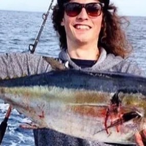 a person holding a fish in the water