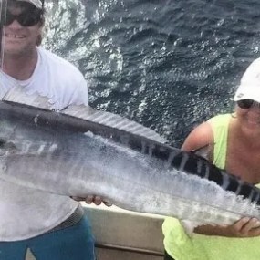 a man holding a fish in the water