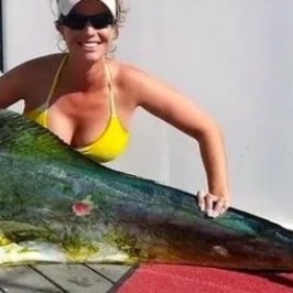 a woman holding a fish