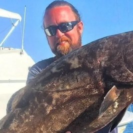 a man holding a fish