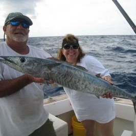 a man holding a fish in the water