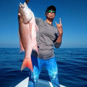 a man holding a fish swimming under water