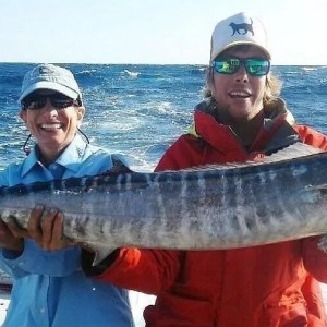 a man holding a fish in the water