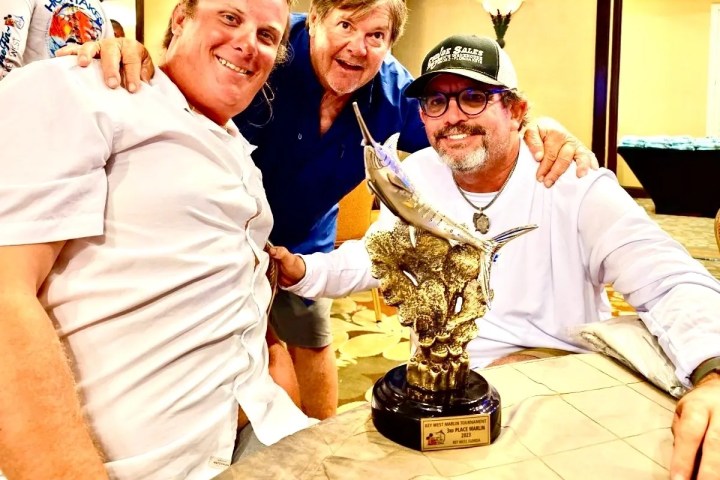 Cowboy Cowgirl Sportfishing crew and happy customer celebrating a marlin tournament win in Key West, Florida