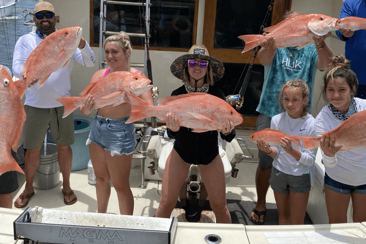 Family with kids on a fishing charter in Key West, Florida, catching snapper and enjoying a fun, guided inshore fishing trip