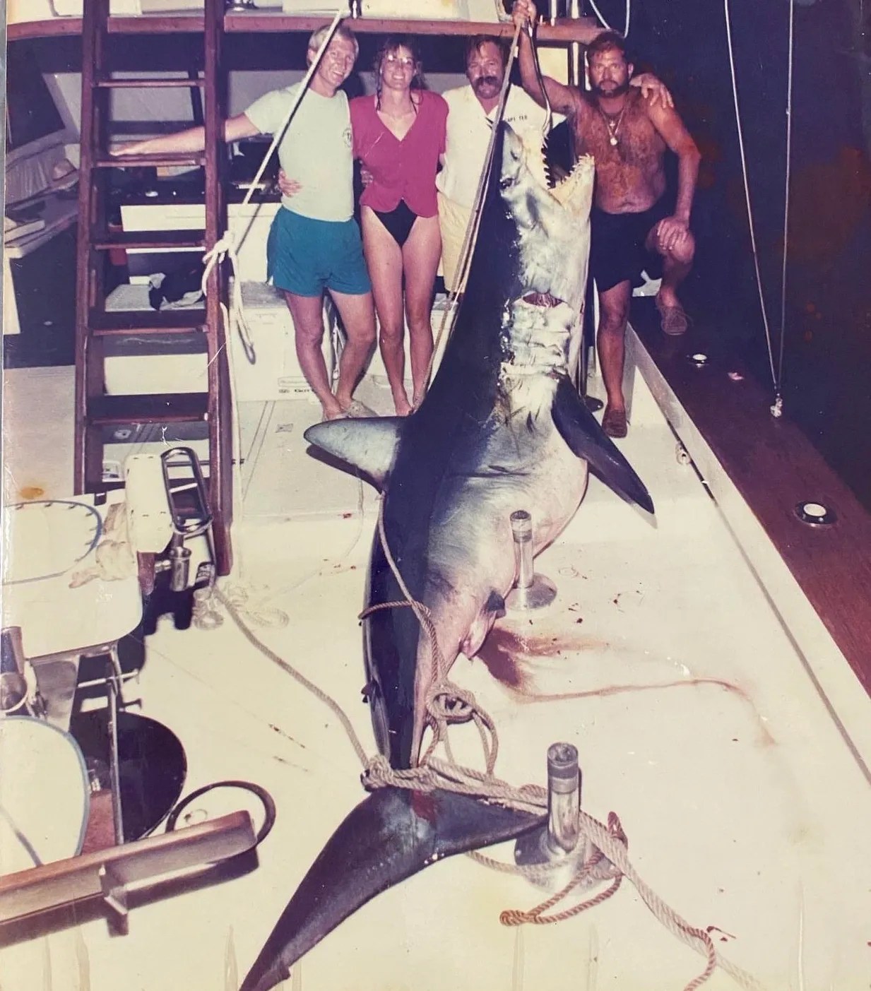 718-Pound Shortfin Mako Shark Caught Offshore in Key West Young couple posing with a 718-pound shortfin mako shark caught during an offshore fishing trip in Key West, Florida, 1980s.