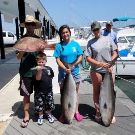 a group of people standing next to a person holding a fish