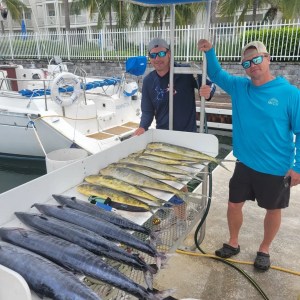 a group of people standing in front of a fence