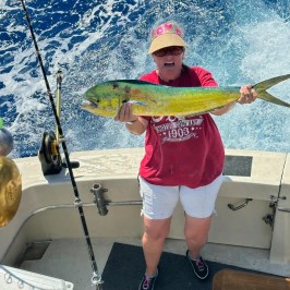 a young boy holding a fish