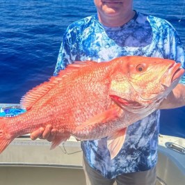 Tony Conrad holding a fish in the water