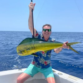a person holding a fish in the water