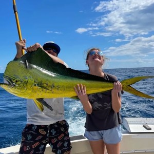 Anglers on a shared fishing charter in Key West reeling in mahi with Cowboy Cowgirl Sportfishing.