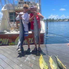 a person holding a fish on a boat in the water