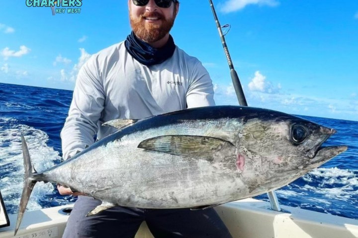 a person holding a fish on a boat